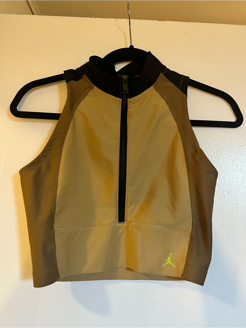 AIR JORDAN WOMENS BODY CON CROP TOP. High-Neck Zip Crop Top with Neon Jumpman.